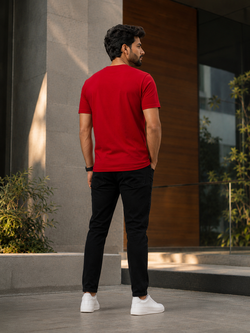 Back view of a model wearing Beer on Friday graphic printed t shirts for men with black pant and white sneakers outdoors.