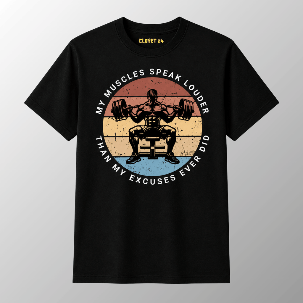 A black short-sleeve t-shirt with a vintage style graphic of a weightlifter squatting a barbell. The graphic features a circular design with the text 'MY MUSCLES SPEAK LOUDER THAN MY EXCUSES EVER DID'.