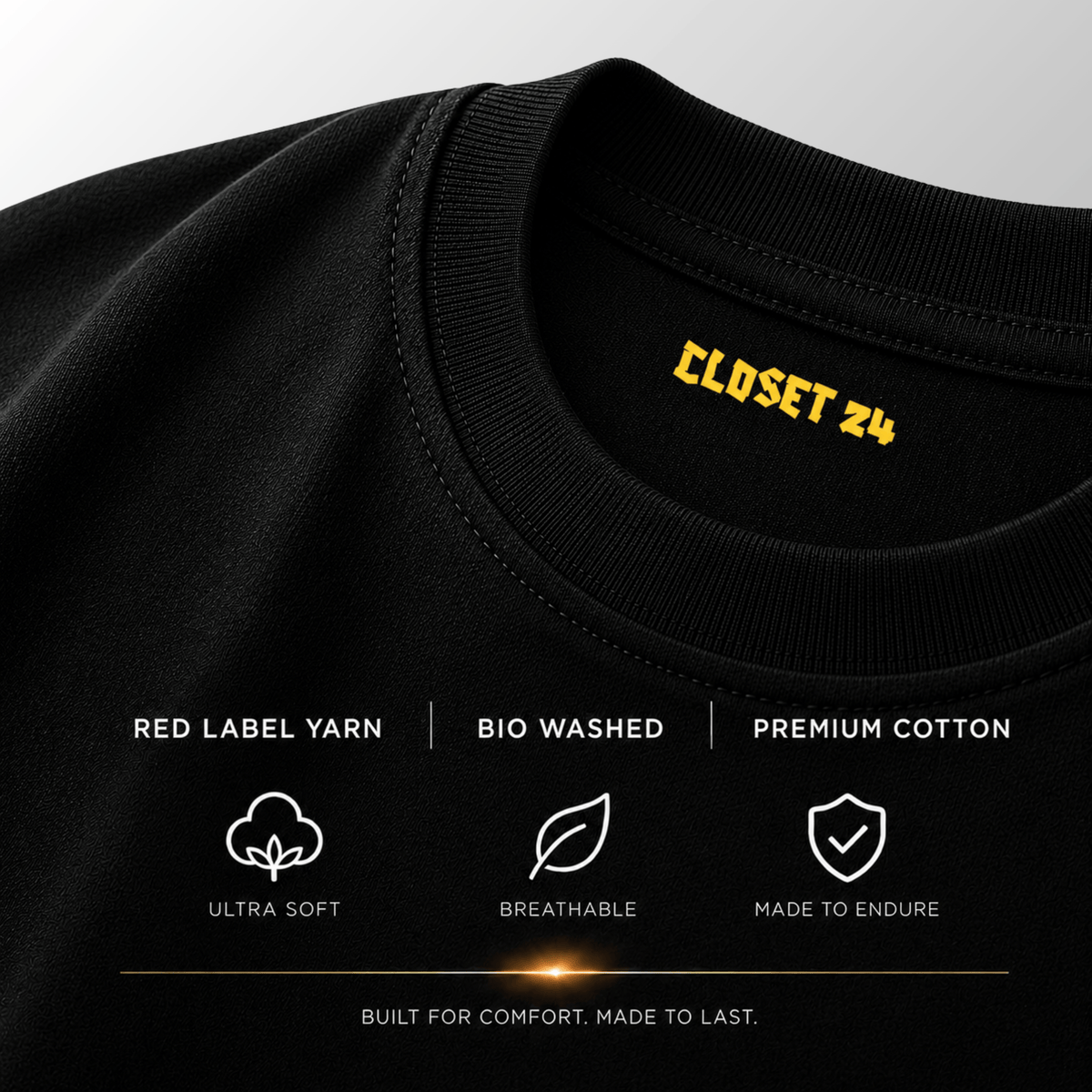 Close up of the black t shirt for men showcasing the CLOSET 24 neck print with Red Label Yarn and bio-washed fabric.